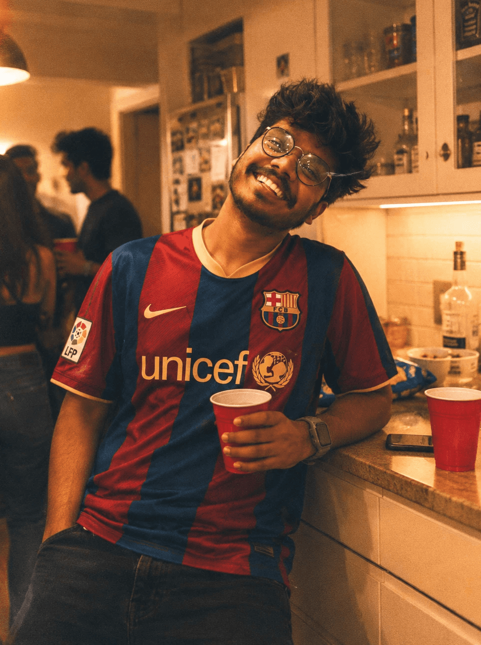 Amal smiling in a Barcelona football jersey